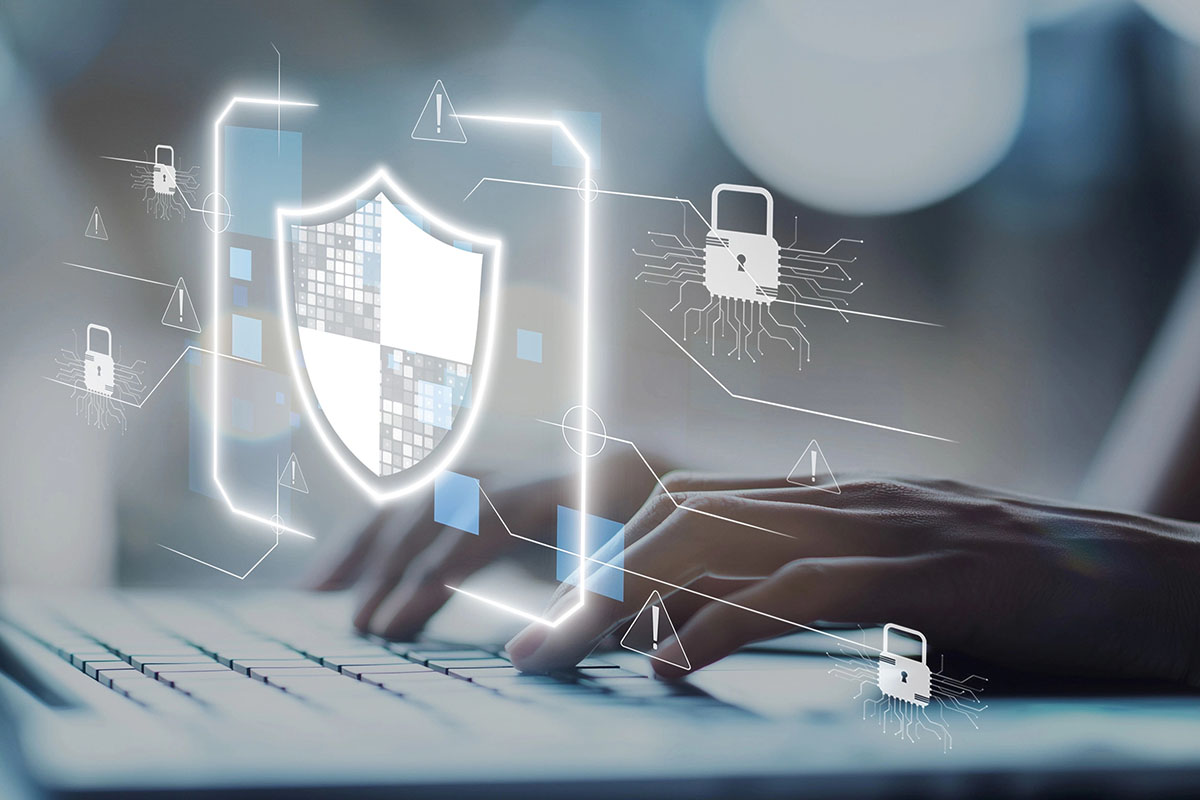 An individual types on a keyboard, surrounded by digital graphics representing cybersecurity elements, including a shield and padlock icons, indicating protection against online threats.