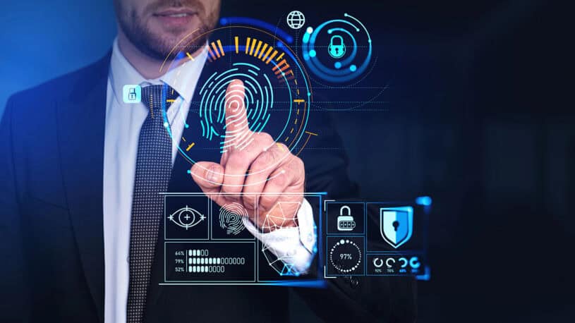 A businessman in a suit interacts with a digital touchscreen displaying biometric security icons, including a fingerprint, lock symbols, and data analytics metrics in blue and orange hues.
