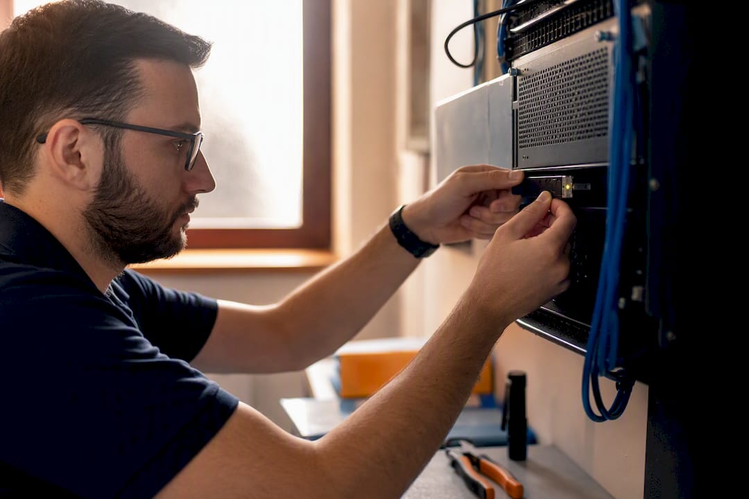 Technician connecting encryption device in server rack