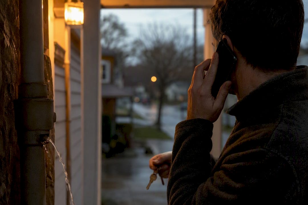Homeowner making urgent repair call on phone